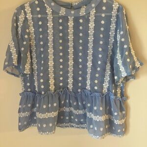 Blue sheer peplum top with white embroidery. Size Large.